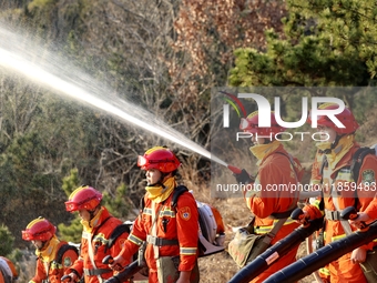 A comprehensive combat drill for forest fire emergency response takes place in Qingdao, China, on December 11, 2024. (