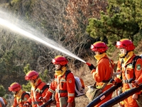 A comprehensive combat drill for forest fire emergency response takes place in Qingdao, China, on December 11, 2024. (