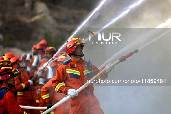 A comprehensive combat drill for forest fire emergency response takes place in Qingdao, China, on December 11, 2024. 