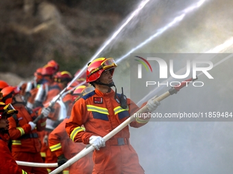 A comprehensive combat drill for forest fire emergency response takes place in Qingdao, China, on December 11, 2024. (