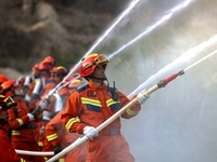 A comprehensive combat drill for forest fire emergency response takes place in Qingdao, China, on December 11, 2024. (