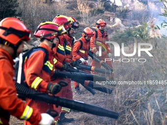 A comprehensive combat drill for forest fire emergency response takes place in Qingdao, China, on December 11, 2024. (