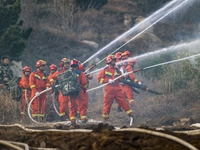 A comprehensive combat drill for forest fire emergency response takes place in Qingdao, China, on December 11, 2024. (