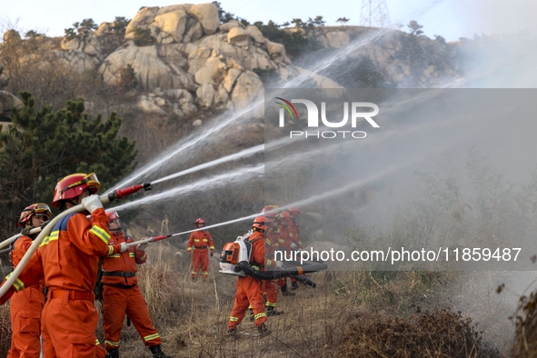 A comprehensive combat drill for forest fire emergency response takes place in Qingdao, China, on December 11, 2024. 