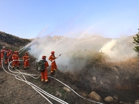 A comprehensive combat drill for forest fire emergency response takes place in Qingdao, China, on December 11, 2024. (