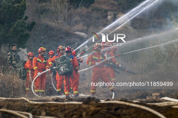 A comprehensive combat drill for forest fire emergency response takes place in Qingdao, China, on December 11, 2024. 