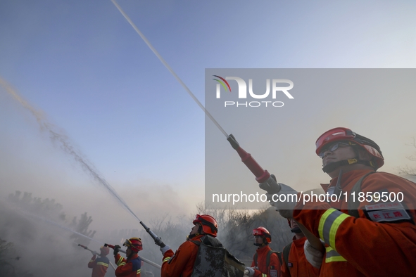 A comprehensive combat drill for forest fire emergency response takes place in Qingdao, China, on December 11, 2024. 