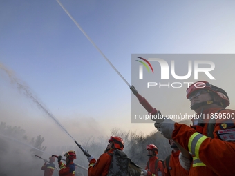 A comprehensive combat drill for forest fire emergency response takes place in Qingdao, China, on December 11, 2024. (