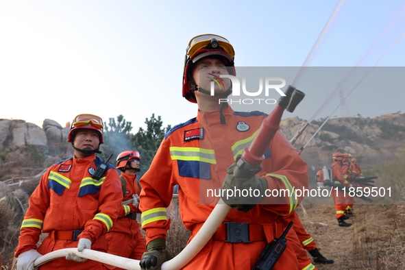 A comprehensive combat drill for forest fire emergency response takes place in Qingdao, China, on December 11, 2024. 