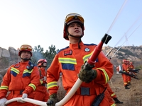 A comprehensive combat drill for forest fire emergency response takes place in Qingdao, China, on December 11, 2024. (