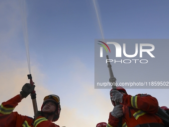 A comprehensive combat drill for forest fire emergency response takes place in Qingdao, China, on December 11, 2024. (