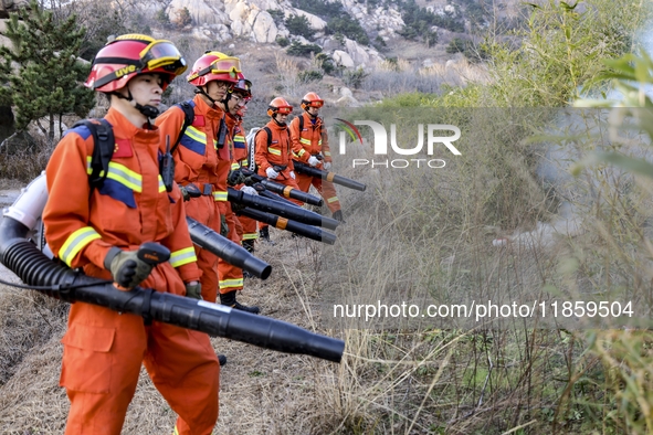 A comprehensive combat drill for forest fire emergency response takes place in Qingdao, China, on December 11, 2024. 