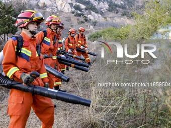 A comprehensive combat drill for forest fire emergency response takes place in Qingdao, China, on December 11, 2024. (