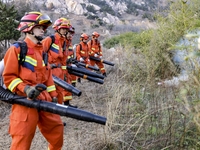 A comprehensive combat drill for forest fire emergency response takes place in Qingdao, China, on December 11, 2024. (