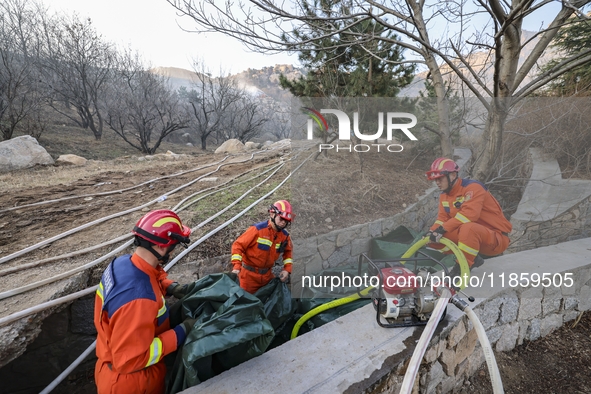 A comprehensive combat drill for forest fire emergency response takes place in Qingdao, China, on December 11, 2024. 