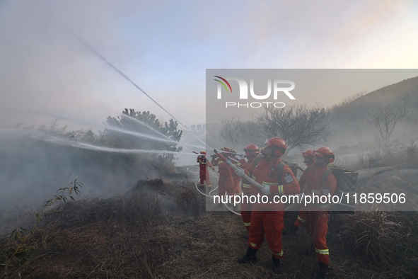 A comprehensive combat drill for forest fire emergency response takes place in Qingdao, China, on December 11, 2024. 