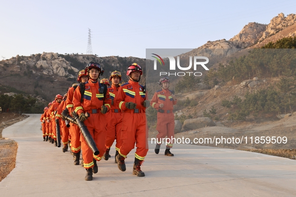 A comprehensive combat drill for forest fire emergency response takes place in Qingdao, China, on December 11, 2024. 