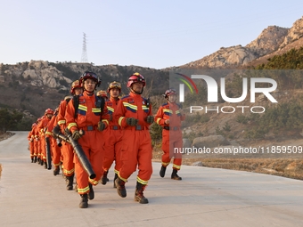 A comprehensive combat drill for forest fire emergency response takes place in Qingdao, China, on December 11, 2024. (