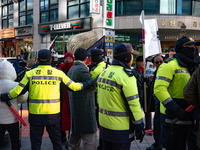 Police mediate between supporters of President Yoon Suk-yeol and those calling for his impeachment to prevent conflicts in front of the Peop...