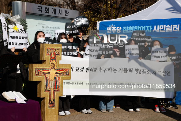 Approximately 50 members of the Catholic Youth Solidarity hold a press conference in front of the National Assembly in Yeouido, Seoul, South...