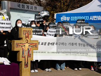 Approximately 50 members of the Catholic Youth Solidarity hold a press conference in front of the National Assembly in Yeouido, Seoul, South...