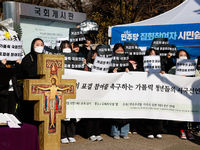 Approximately 50 members of the Catholic Youth Solidarity hold a press conference in front of the National Assembly in Yeouido, Seoul, South...