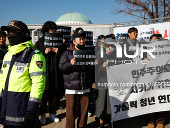 Approximately 50 members of the Catholic Youth Solidarity hold a press conference in front of the National Assembly in Yeouido, Seoul, South...