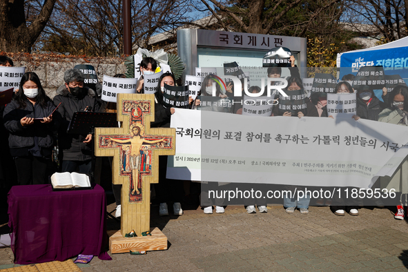 Approximately 50 members of the Catholic Youth Solidarity hold a press conference in front of the National Assembly in Yeouido, Seoul, South...