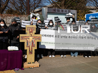 Approximately 50 members of the Catholic Youth Solidarity hold a press conference in front of the National Assembly in Yeouido, Seoul, South...