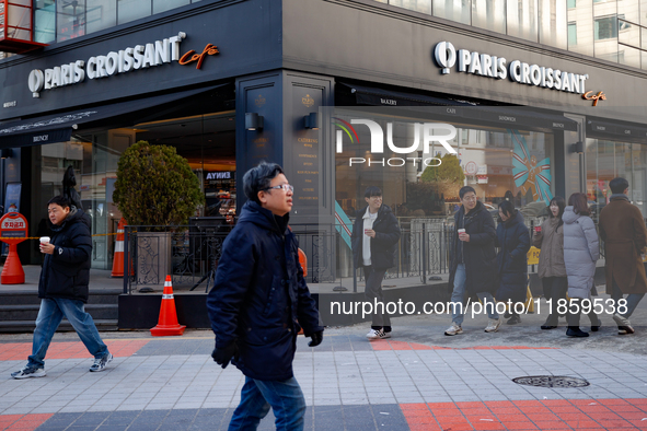 A cafe next to the People Power Party's central headquarters in Yeouido, Seoul, South Korea, on December 12, 2024, sees a citizen prepay KRW...