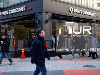 A cafe next to the People Power Party's central headquarters in Yeouido, Seoul, South Korea, on December 12, 2024, sees a citizen prepay KRW...