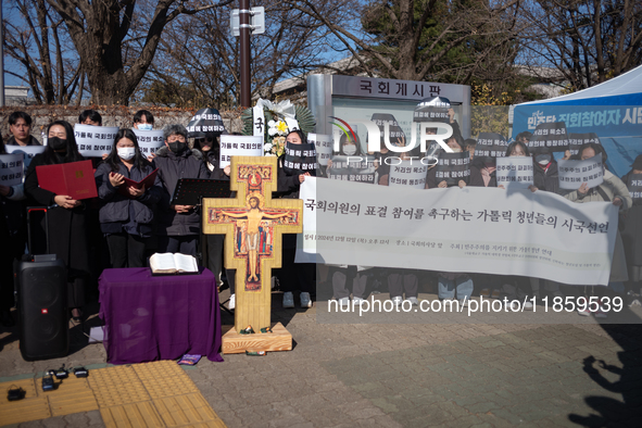 Approximately 50 members of the Catholic Youth Solidarity hold a press conference in front of the National Assembly in Yeouido, Seoul, South...