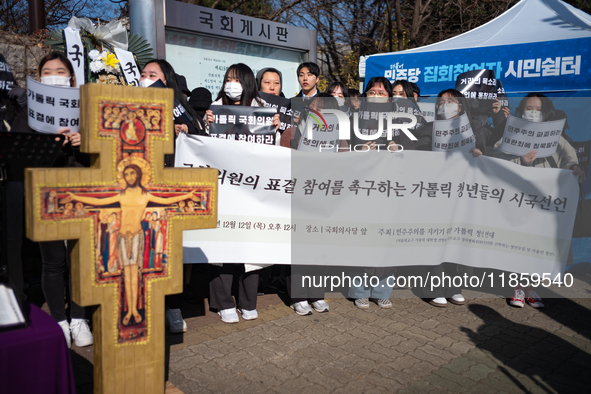 Approximately 50 members of the Catholic Youth Solidarity hold a press conference in front of the National Assembly in Yeouido, Seoul, South...