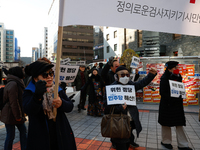 A small group of President Yoon Suk-yeol's supporters, primarily elderly individuals, holds a rally in front of the People Power Party's cen...