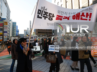 A small group of President Yoon Suk-yeol's supporters, primarily elderly individuals, holds a rally in front of the People Power Party's cen...