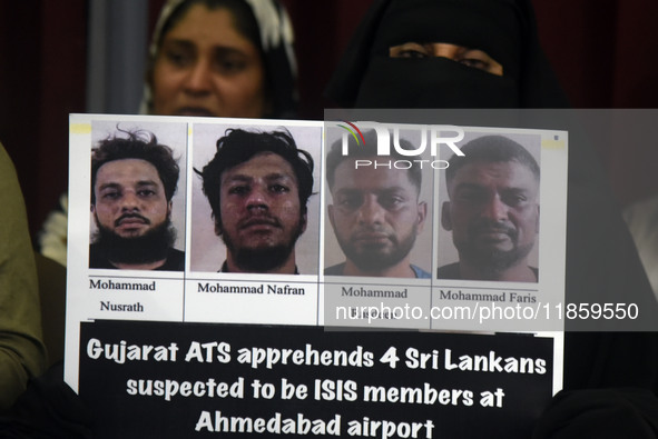 A family member holds placards of the suspects during a press conference in Colombo, Sri Lanka, on December 12, 2024. Four Sri Lankan nation...