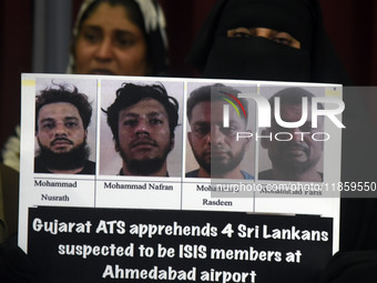 A family member holds placards of the suspects during a press conference in Colombo, Sri Lanka, on December 12, 2024. Four Sri Lankan nation...