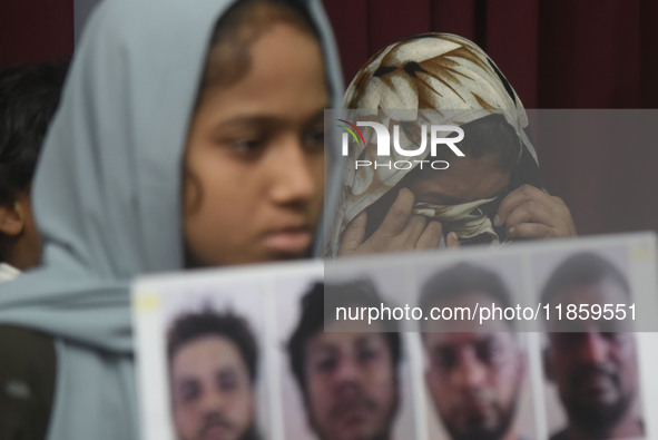 Family members wipe his tears at a media conference in Colombo, Sri Lanka, on December 12, 2024. Four Sri Lankan nationals are arrested by I...