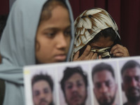 Family members wipe his tears at a media conference in Colombo, Sri Lanka, on December 12, 2024. Four Sri Lankan nationals are arrested by I...