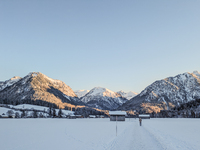 A man walks through the snowy landscape near Bavarian Oberstdorf in Bavaria, Swabia, Oberallgau, Germany, on January 20, 2024. Oberstdorf is...