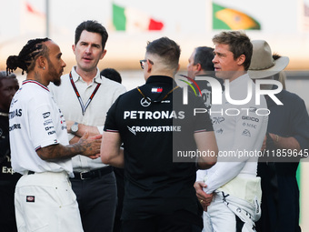 Lewis Hamilton of Mercedes, Brad Pitt, actor playing Sonny Hayes, a driver of the fictional Apex APXGP F1 team in the upcoming 'F1' movie an...