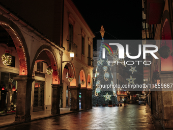 A big Christmas tree and Christmas lights adorn the arcades and the city center in Cava de'Tirreni, Salerno, Italy, on December 11, 2024. (