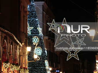 A big Christmas tree and Christmas lights adorn the arcades and the city center in Cava de'Tirreni, Salerno, Italy, on December 11, 2024. (