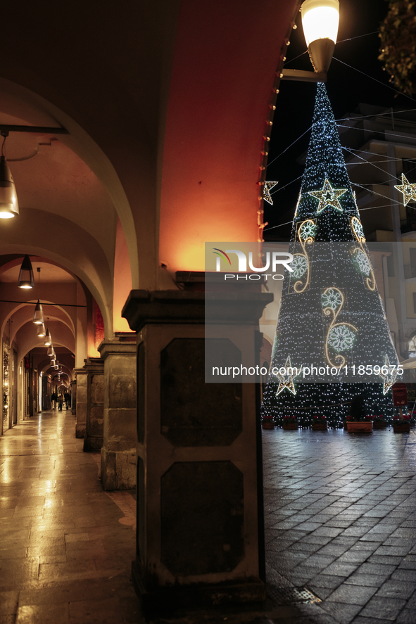 A big Christmas tree and Christmas lights adorn the arcades and city center in Cava de'Tirreni, Salerno, Italy, on December 11, 2024. 