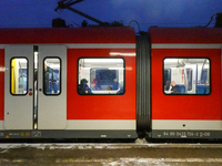 Passengers are inside a red Deutsche Bahn S-Bahn train at the Gauting suburban station in Bavaria, Germany, on November 22, 2024.(