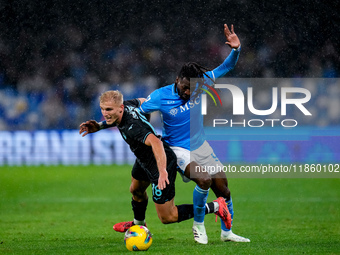 Andre-Frank Zambo Anguissa of SSC Napoli and Gustav Isaksen of SS Lazio compete for the ball during the serie Serie A Enilive match between...