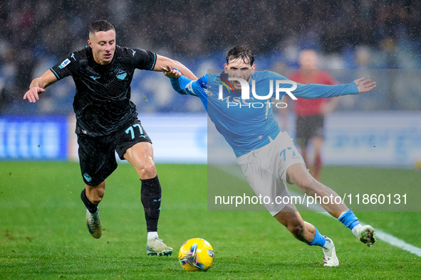 Adam Marusic of SS Lazio and Khvicha Kvaratskhelia of SSC Napoli compete for the ball during the serie Serie A Enilive match between SSC Nap...