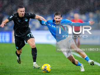 Adam Marusic of SS Lazio and Khvicha Kvaratskhelia of SSC Napoli compete for the ball during the serie Serie A Enilive match between SSC Nap...