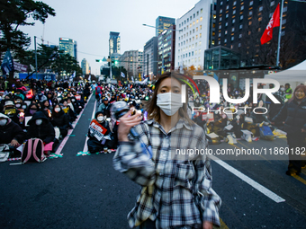 A student who completes the college entrance exam this year dances while participating in a protest calling for the impeachment of President...