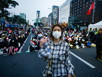 A student who completes the college entrance exam this year dances while participating in a protest calling for the impeachment of President...